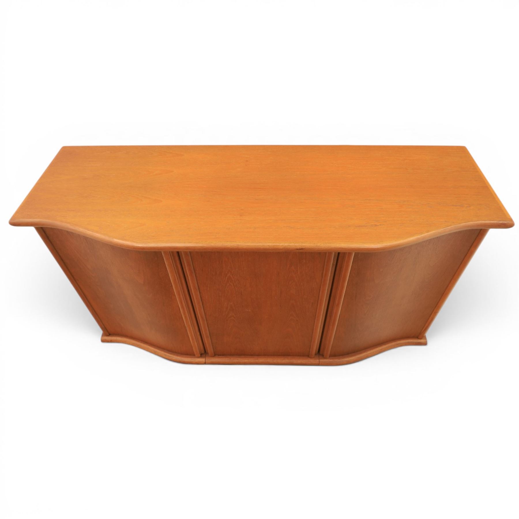 Skovby - model '400T' teak sideboard, shaped top above three cupboard doors with recessed handles, fitted with shelving and drawers