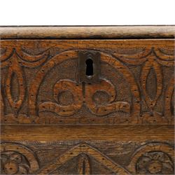 18th century carved oak coffer, rectangular hinged top over a lunette-carved frieze and tracery-style carved triple panelled front, the lower rail carved with repeating anthemion motifs, on square feet