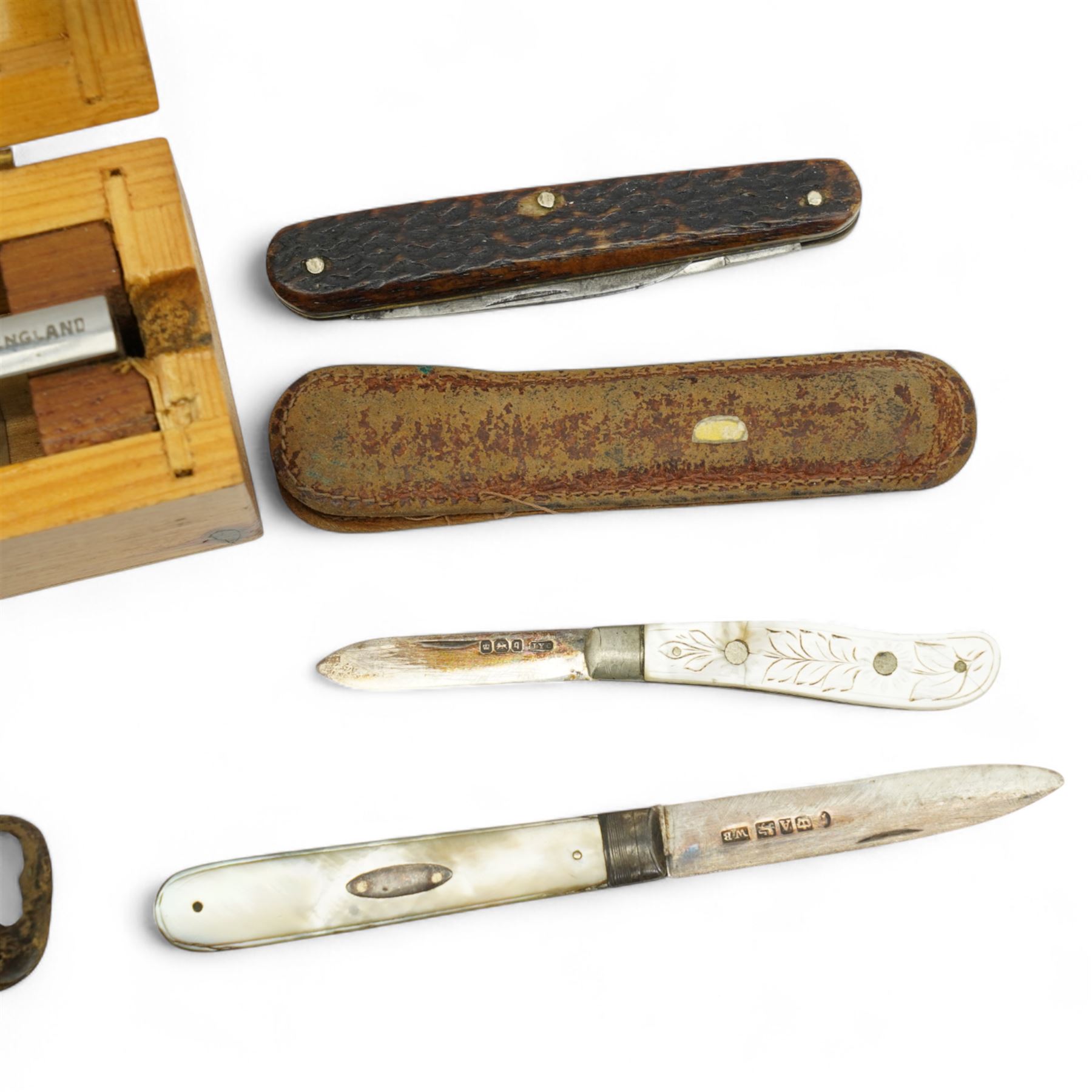 Two mother of pearl fruit knives with silver blades, 19th century pen knife with horn case by William Oates, Sheffield, another by Hunter, Sheffield, various other pen knives, cut throat razor by Barlow, Sheffield and a re-sharpening tool