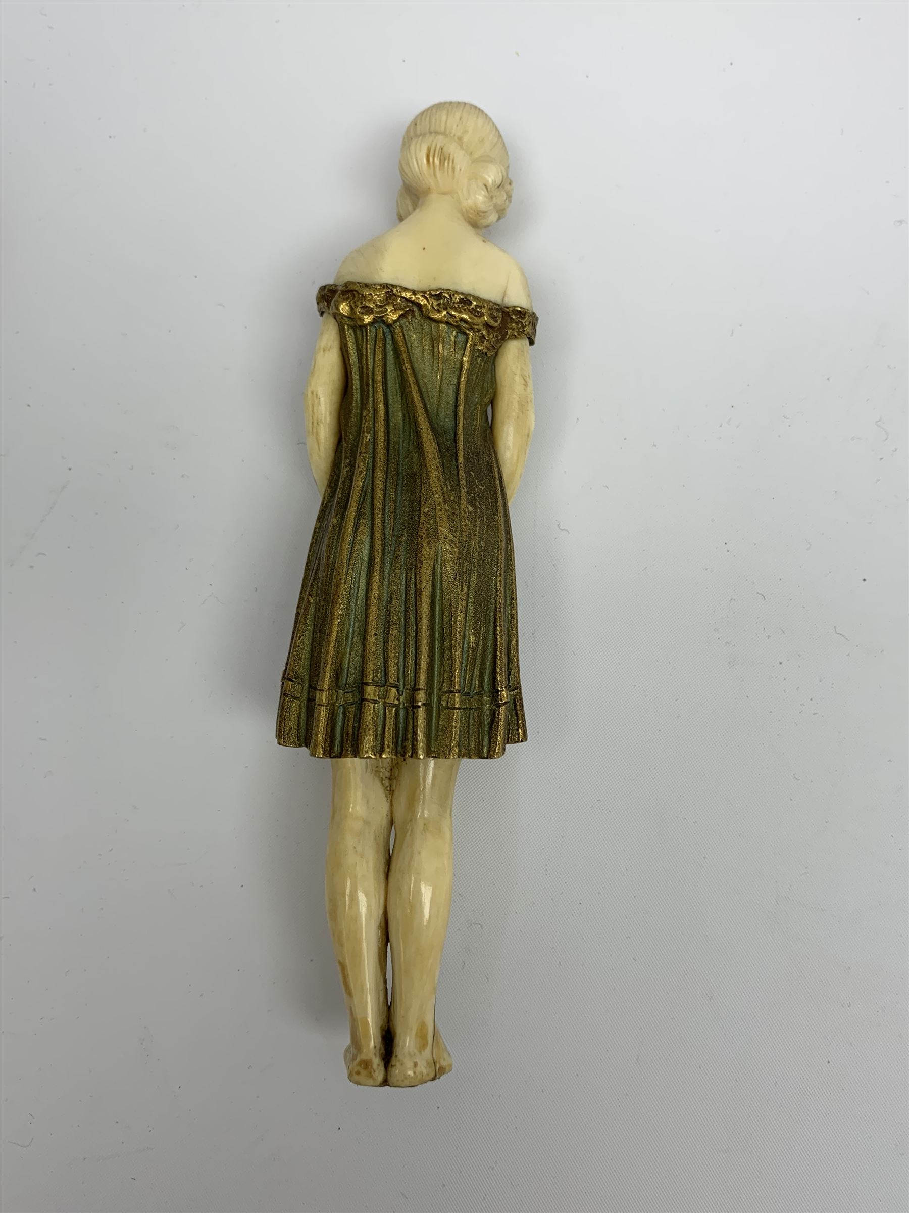 Demetre Chiparus (1886-1947): Innocence, a gilt bronze and ivory figure, circa 1925, standing in contemplative post with hands clasped, upon onyx plinth, signed to base, H24.4cm