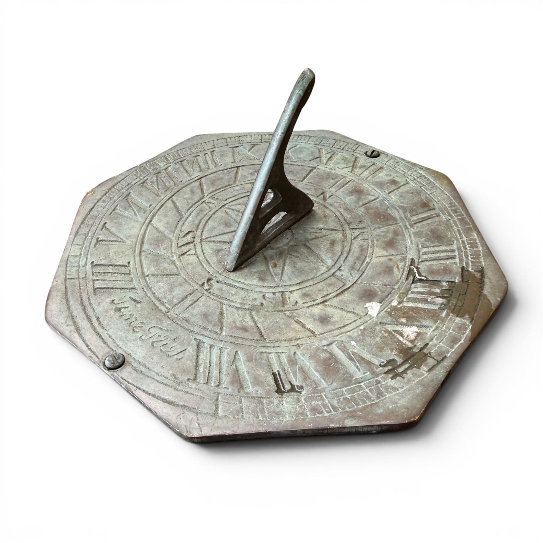 Weathered cast stone sundial, shaped top with metal dial, patterned column
