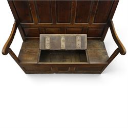 18th century oak high-back settle or hall bench, the panelled back and arm terminals over a hinged box seat, panelled front on short stile feet
