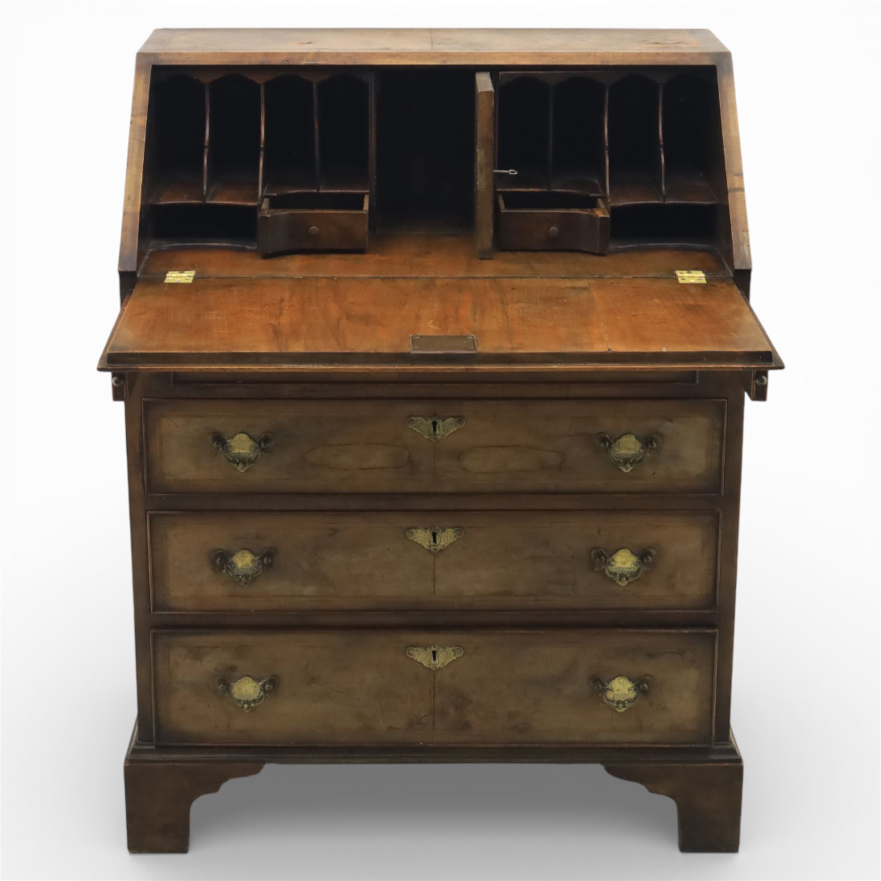19th century walnut bureau of small proportions, the sloping fall enclosing a fitted interior with shaped pigeonholes and small drawers, above four long graduated drawers with feather banded walnut veneers, fitted with brass swan neck handles and escutcheons, raised on shaped bracket feet