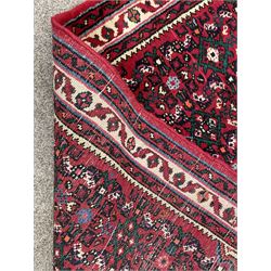 Persian red ground runner rug, the field with central lozenge medallion surround by repeating Herati motifs, triple band border