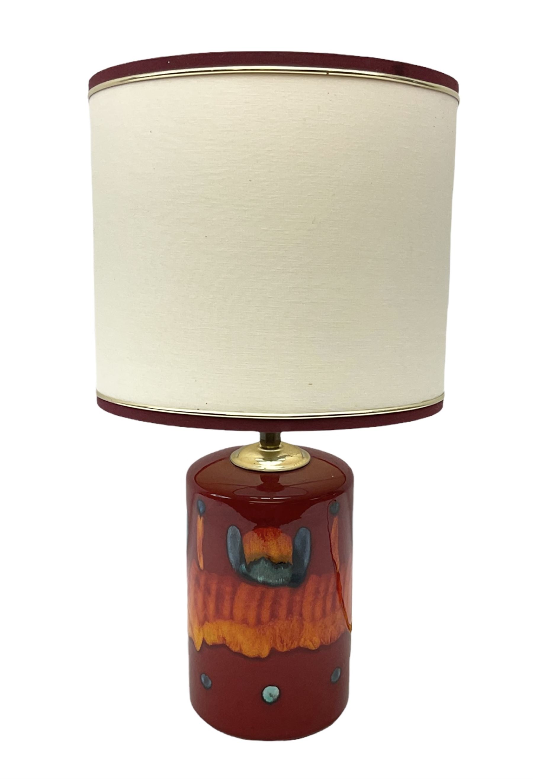 Poole Pottery table lamp in Volcano pattern of cylindrical form, with a cream lampshade, lamp H30cm