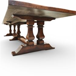 Country House 12' oak and fruitwood refectory dining table, the substantial rectangular plank top with cleated ends and chamfered edge, raised on twin trestle end square tapering and turned baluster supports with sledge feet and chamfered united by a long stretcher rail