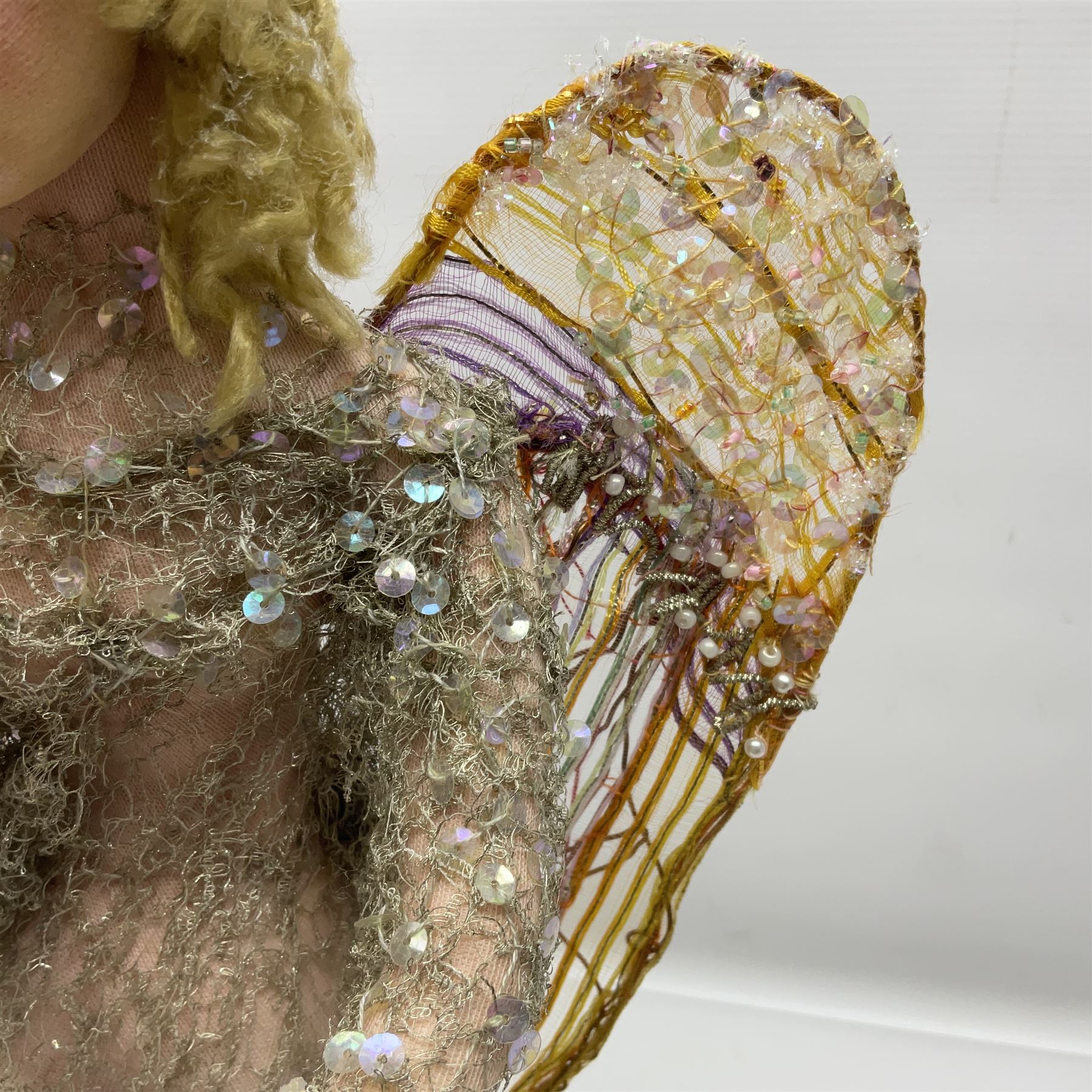 Anna Meszaros Hungary - hand made needlework figurine of an Angel with metallic lace full length dress and open threadwork wings; on moulded base H45cm Auctioneer's Note: Anna Meszaros came to England from her native Hungary in 1959 to marry an English businessman she met while demonstrating her art at the 1958 Brussels Exhibition. Shortly before she left for England she was awarded the title of Folk Artist Master by the Hungarian Government. Anna was a gifted painter of mainly portraits and sculptress before starting to make her figurines which are completely hand made and unique, each with a character and expression of its own. The hands, feet and face are sculptured by layering the material and pulling the features into place with needle and thread. She died in Hull in 1998.