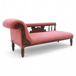 Late Victorian mahogany chaise longue, of scroll-ended form, upholstered in red diamond-patterned fabric with padded back and scroll-carved support, open arm with carved foliate and turned upright, raised on turned tapering legs 
