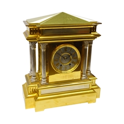 Large late Victorian brass mantel clock in the form of a Roman Temple, the break front top on six Corinthian column supports, circular silvered dial with applied Roman numerals, twin train movement stamped H.P & Co. 374, striking the half hours on a bell, with key and pendulum, H45cm, W39cm  