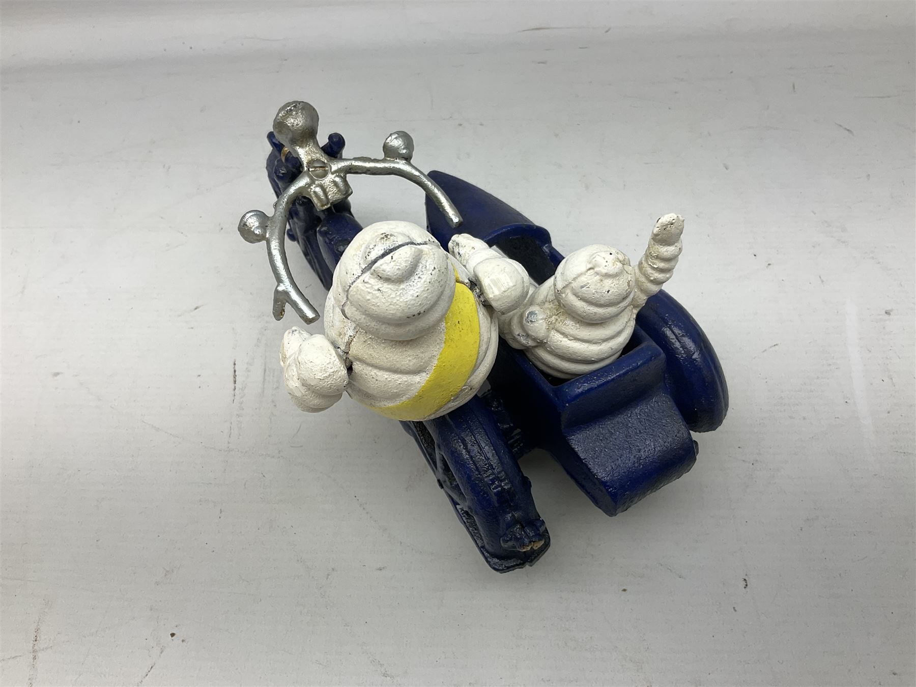 Cast iron figure of Michelin Man on motorbike modelled with smaller seated Michelin man in sidecar, H16cm