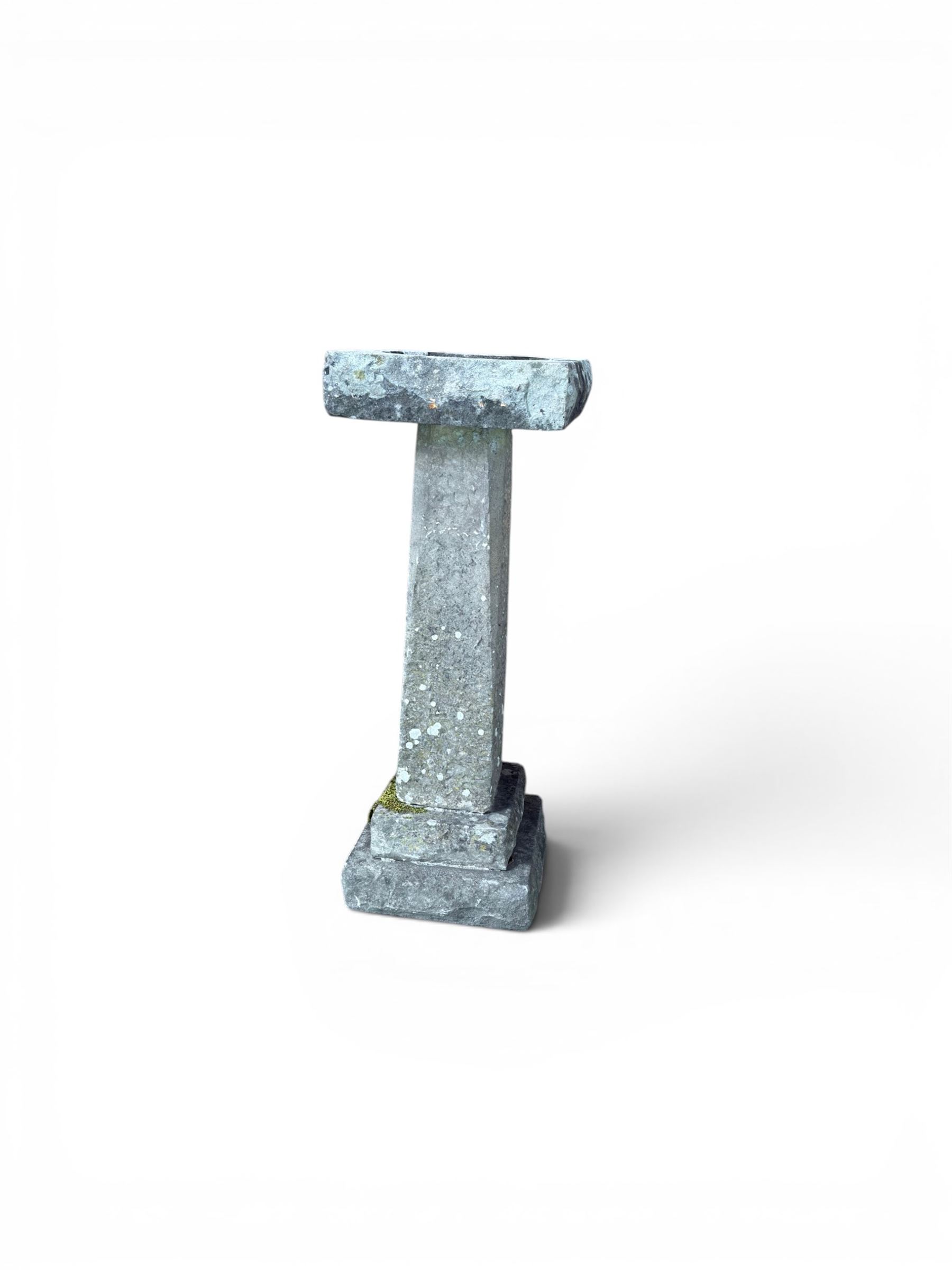 19th century weathered sandstone birdbath, formed in four sections, square top with carved shell bath, raised on tapering column with stepped base