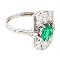 Art Deco 14ct white gold emerald and diamond panel ring, the central round cut emerald of approx 0.45 carat, within a pierced octagonal setting, flanked by a single cut diamond either side and three rows of milgrain set, single cut diamonds, to a reeded shank, stamped 585, total diamond weight approx 0.55 carat