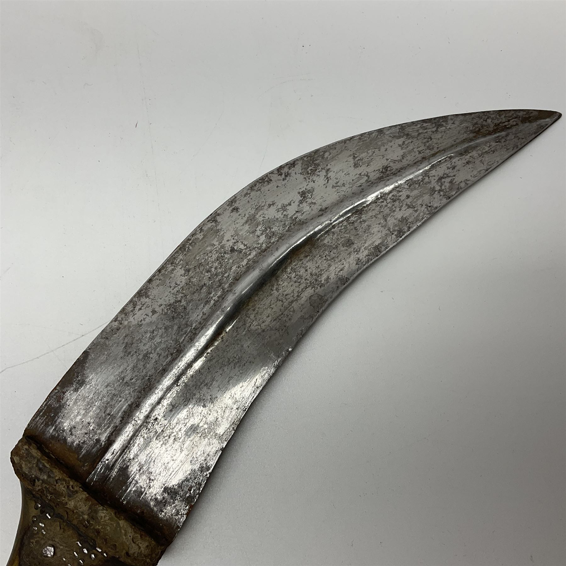 Late 19th century Yemeni Tuza jambiya as worn by religious elite, the 20.5cm curving blade with raised medial ridge, the horn hilt with pique style studwork, in a leather wrapped wooden scabbard with pierced metal mount and leather belt applied with embroidered 'gold' and 'silver' thread work panel; dagger L36cm overall, belt L84cm