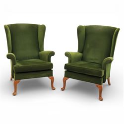 Parker Knoll - pair of 'Penhurst' wingback armchairs upholstered in olive green fabric, on...