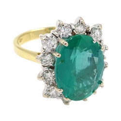 18ct gold oval Zambian emerald and round brilliant cut diamond cluster ring, hallmarked, emerald approx 5.80 carat, total diamond weight approx 1.00 carat