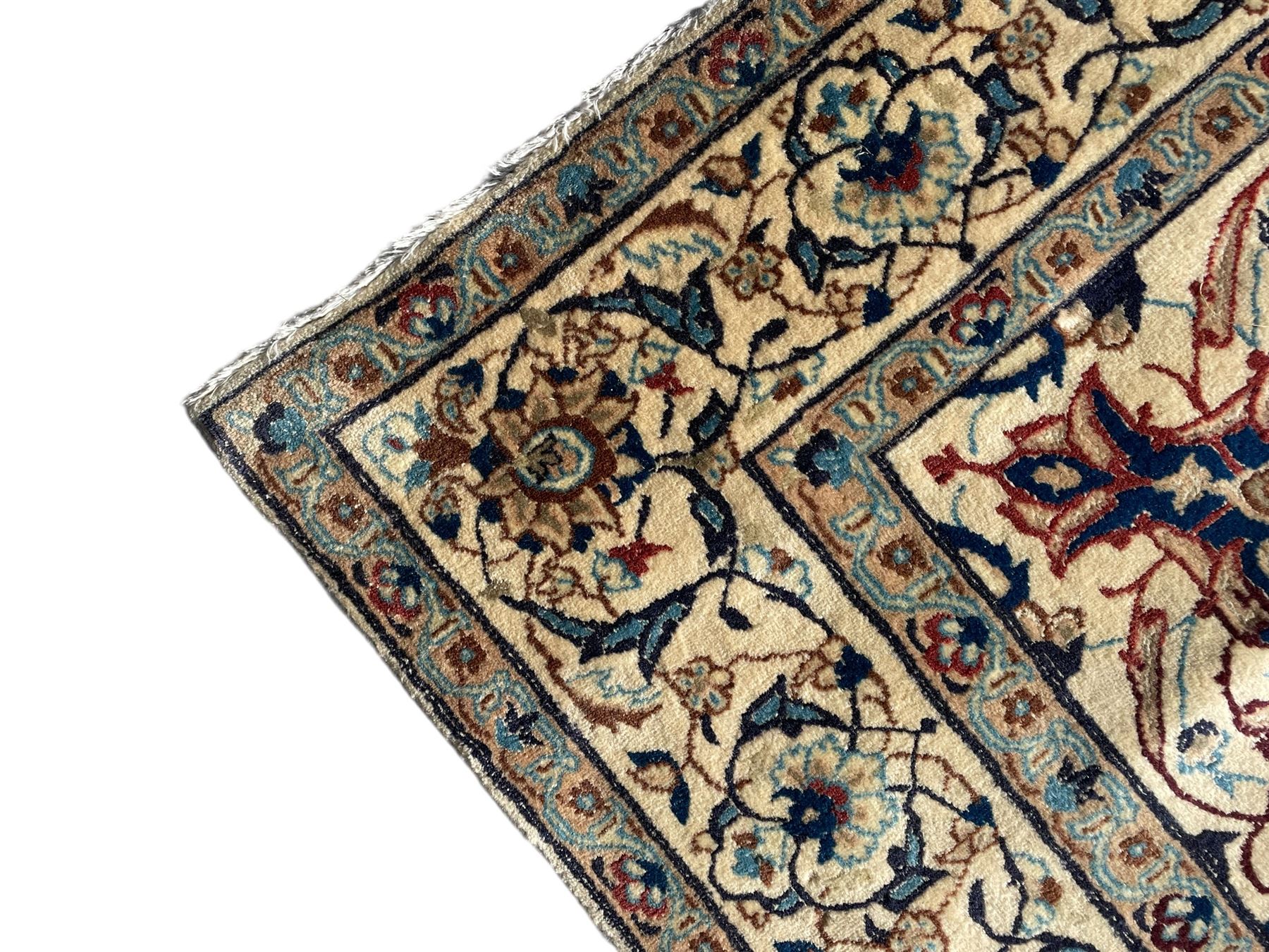 Persian Kashan ivory ground rug, wool with silk inlay, central floral rosette medallion surrounded by trailing flower heads and interlacing leafy branches, the repeating scrolling border decorated with palmettes, within guard stripes