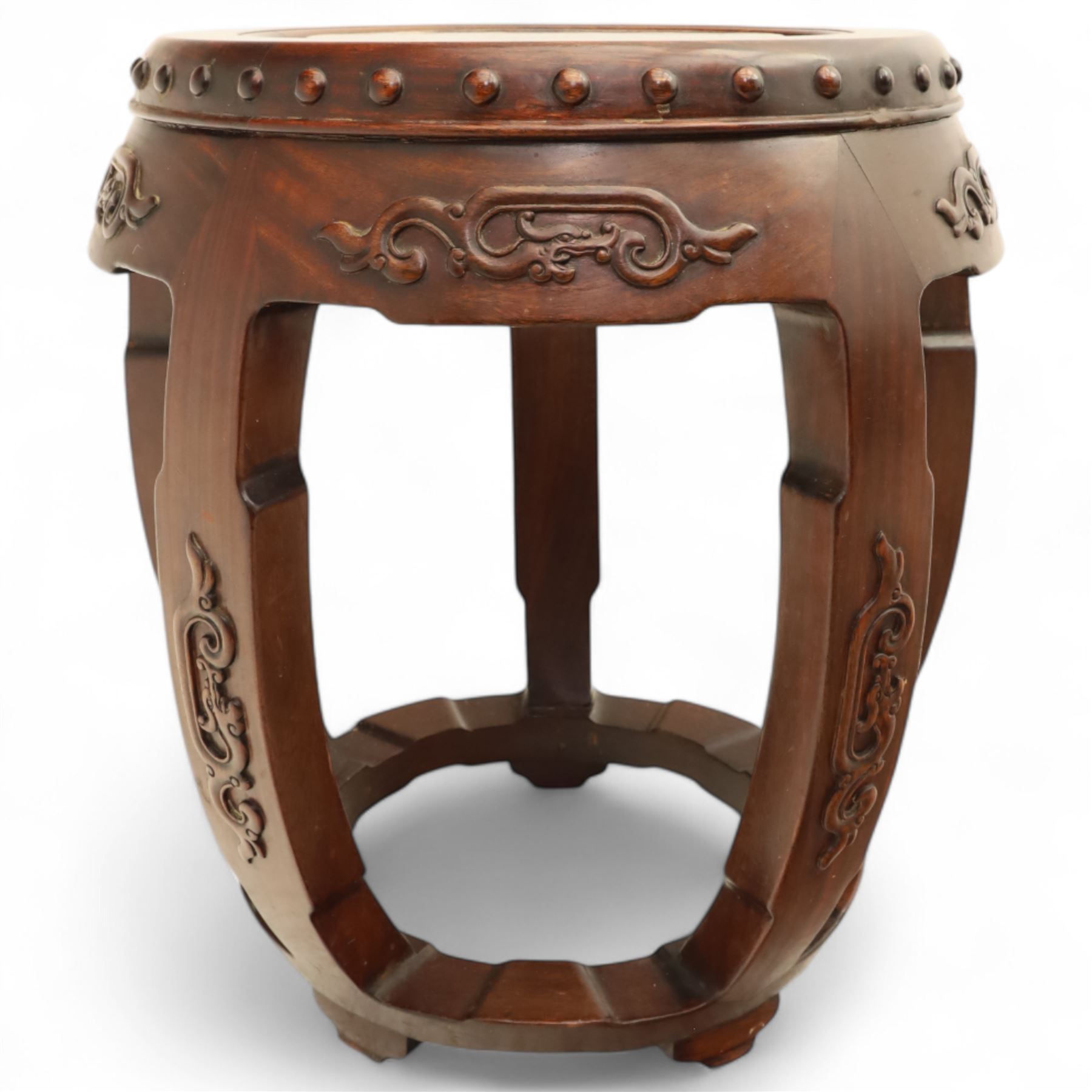 Pair of early 20th century Oriental hardwood barrel seats, of drum form with shaped apron and pierced panels, carved with stylised scrollwork and studded detail to the top