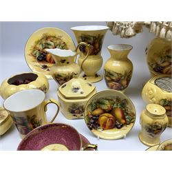 Collection of Aynsley Orchard Gold pattern wares, comprising lamp base, three jars and covers, six vases or various size and form, large jug, lidded dish, pair of cruets, pair of candlesticks, mug, two pin dishes, lobed dish, tea cup, saucer, size plate, and cake plate, and two further cups and saucers, each cup decorated with central Orchard Gold reserve to the interior against a mottled pink or green ground. 