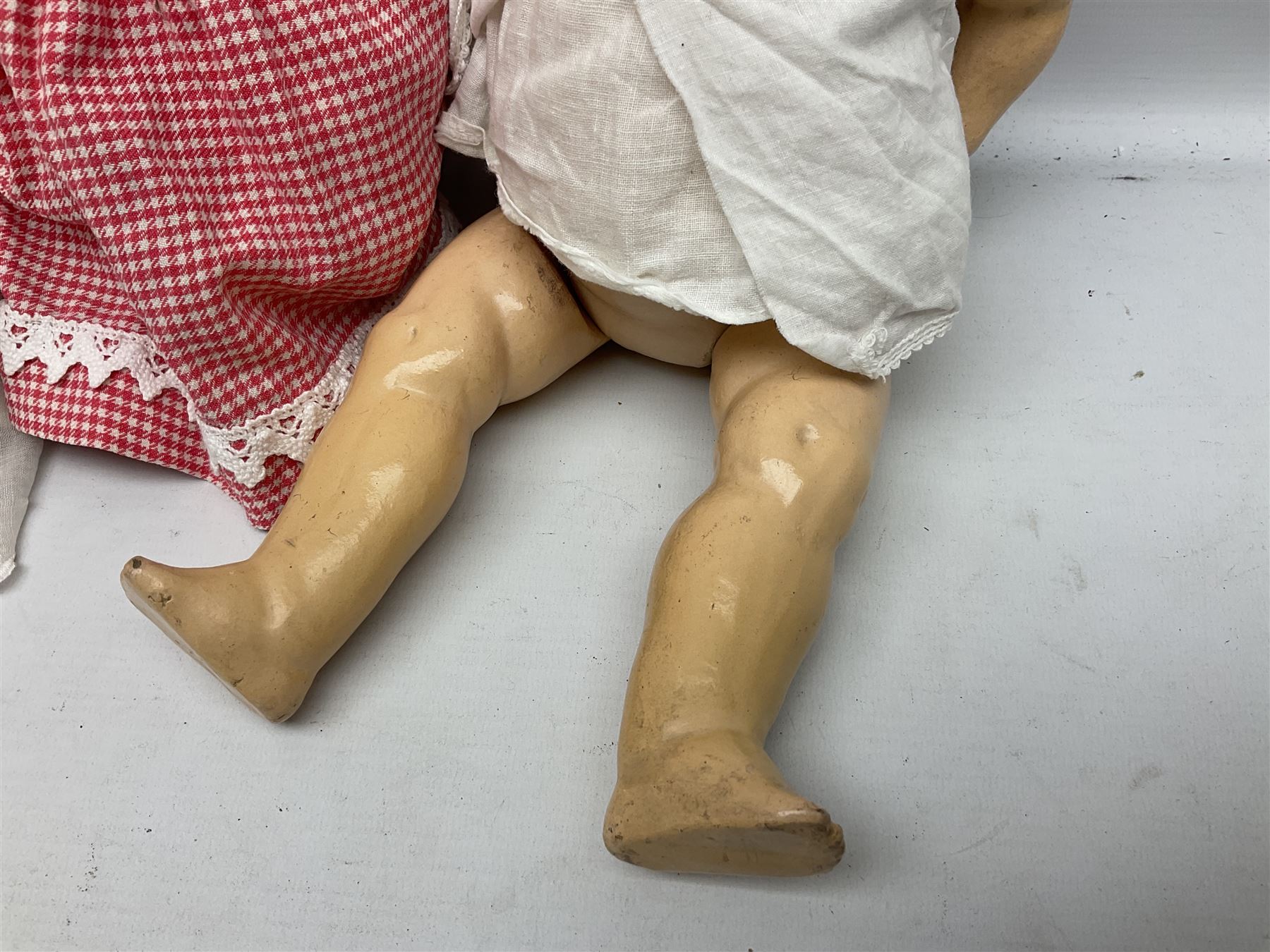 Heubach Koppelsdorf Germany bisque head doll with applied hair, sleeping eyes, open mouth with teeth and composition body with jointed limbs; marked 'Heubach Koppelsdorf 342.6/0 Germany' H34cm; Armand Marseille bisque head baby doll with moulded hair, sleeping eyes, open mouth and composition body with jointed limbs; marked 'A.M. Germany 351./8.K.; and BND London all composition doll (3)