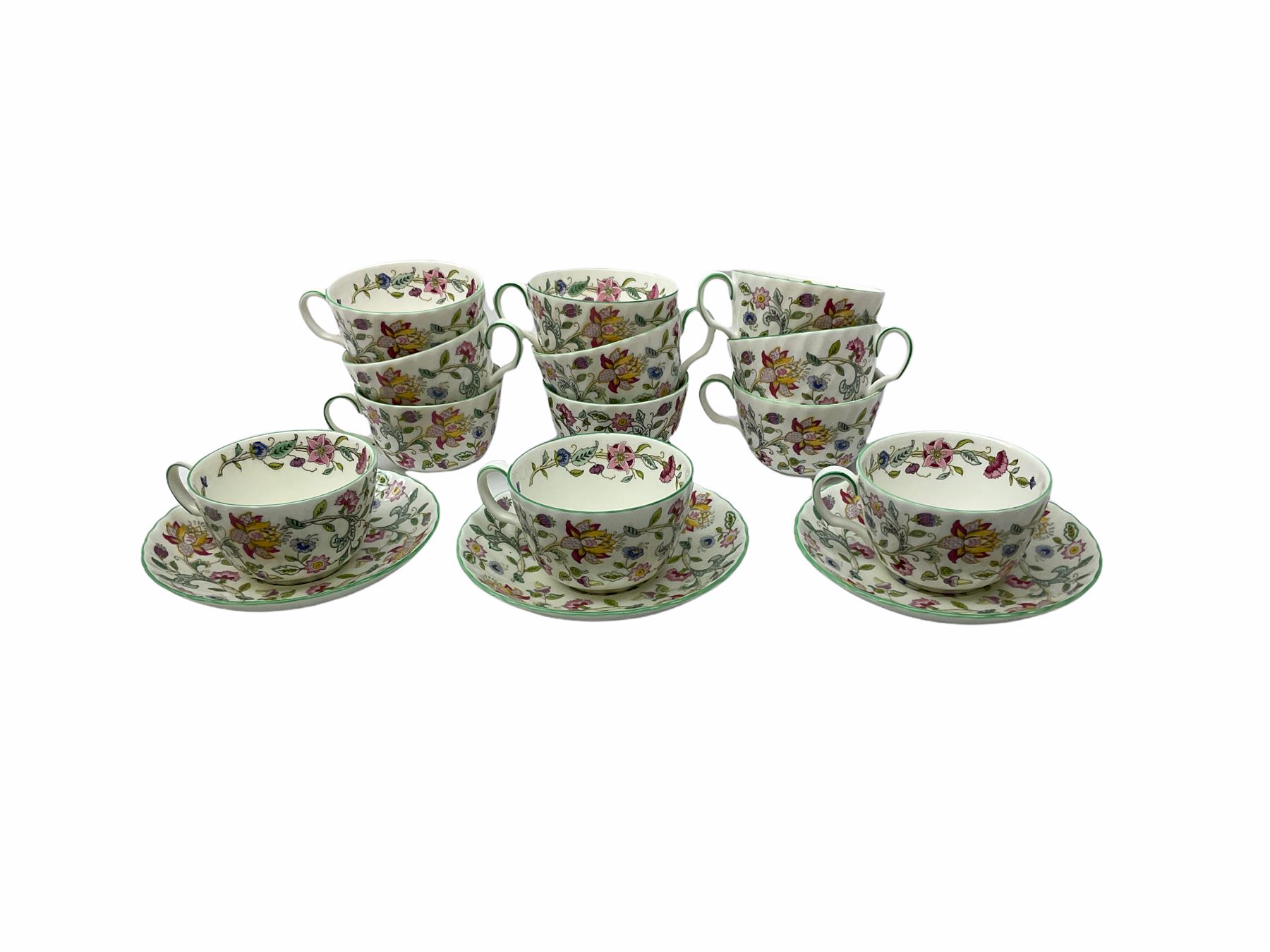 Minton Haddon Hall pattern tea and dinner wares, including basket dish, two covered tureens, six dinner plates, eight dessert plates, twelve tea plates, six soup bowls, six cereal bowls, teapot, coffee pot, milk jug, covered sucrier twelve tea cups and saucers, six mugs, footed bon bon dish, pair of candlestick holders, cake knife and slice etc (81)