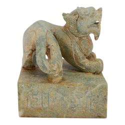 Large 20th century Chinese patinated hardstone dragon seal, the square seal with incised characters to sides and underside, surmounted by the figure of a dragon, H15cm W13cm D13cm