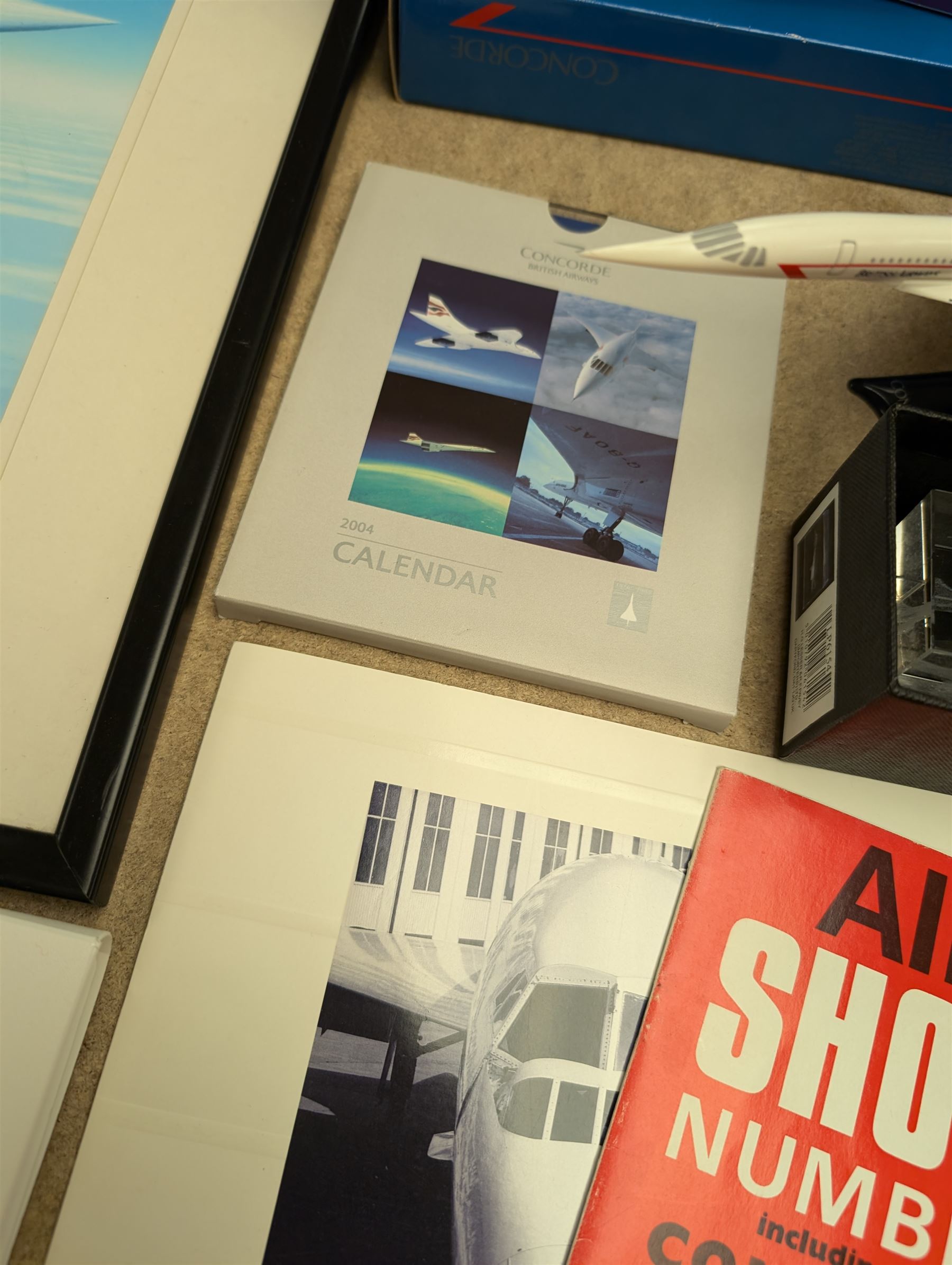 Collection of Concorde memorabilia, including paperweight, limited edition print, calendars, scale model, etc 
