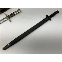 British Enfield 1907 model SMLE bayonet, with 43cm fullered steel blade and metal mounted leather scabbard L58cm overall; and Schmidt-Rubin Model 1918 bayonet the 30cm steel blade marked Elsener Schwyz No.579722; in steel scabbard with leather frog marked G. Bertolini Sellaio Vira/G.Tic 79 L45cm overall (2)