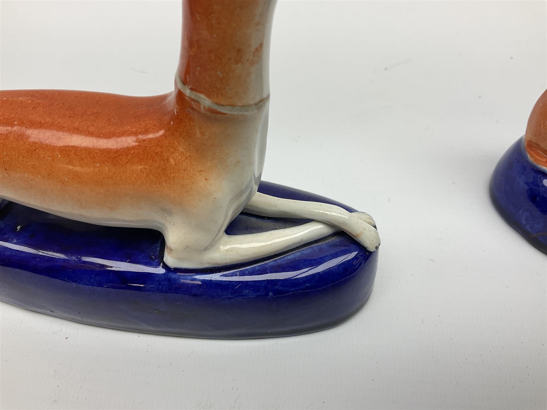 Pair of Staffordshire recumbent greyhound pen holders 