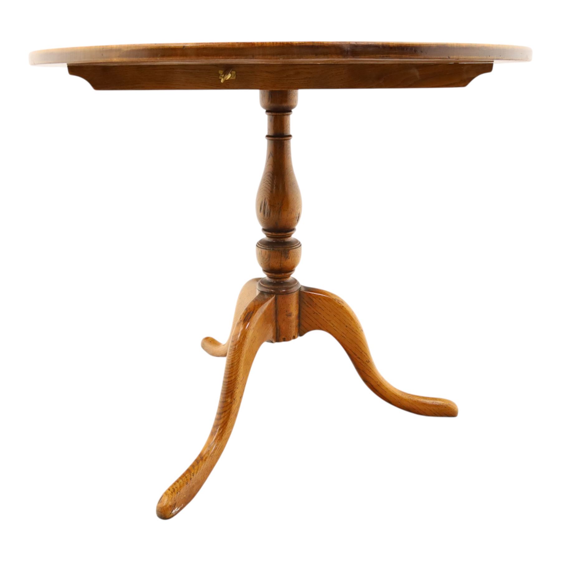 Traditional design golden oak tilt-top tripod table, brass fittings, turned baluster column on splayed supports