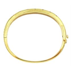 Roberto Coin 'Parisienne' 18ct gold three row round brilliant cut diamond bangle, with a signature round cut ruby to the underside and ruby set clasp, Birmingham 2006, boxed