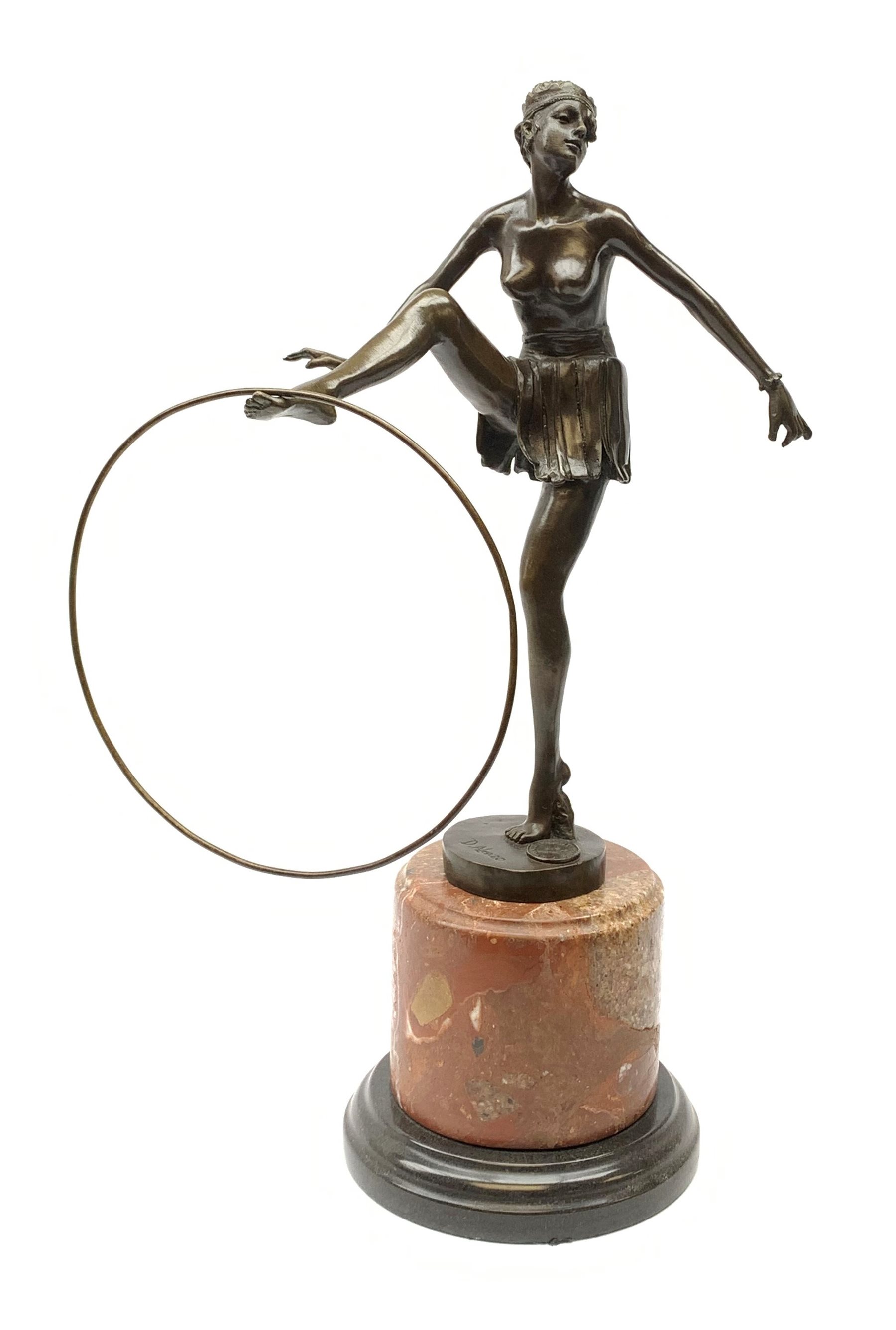 An Art Deco style bronze after D Alonzo, modelled as a female hoop dancer, with impressed mark and foundry mark, raised upon a cylindrical marble base, overall H47cm. 