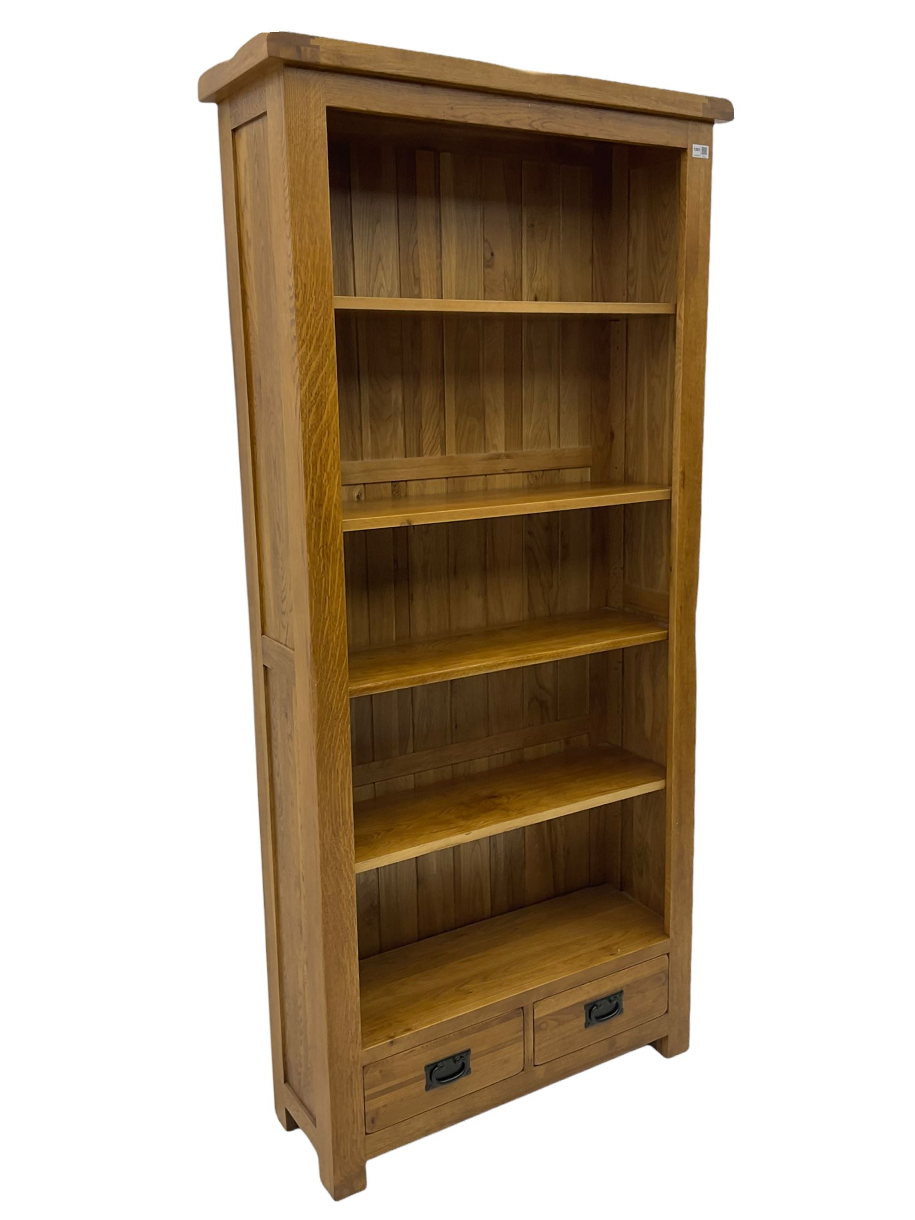 Light oak open bookcase, fitted with two drawers The Furnishings Sale