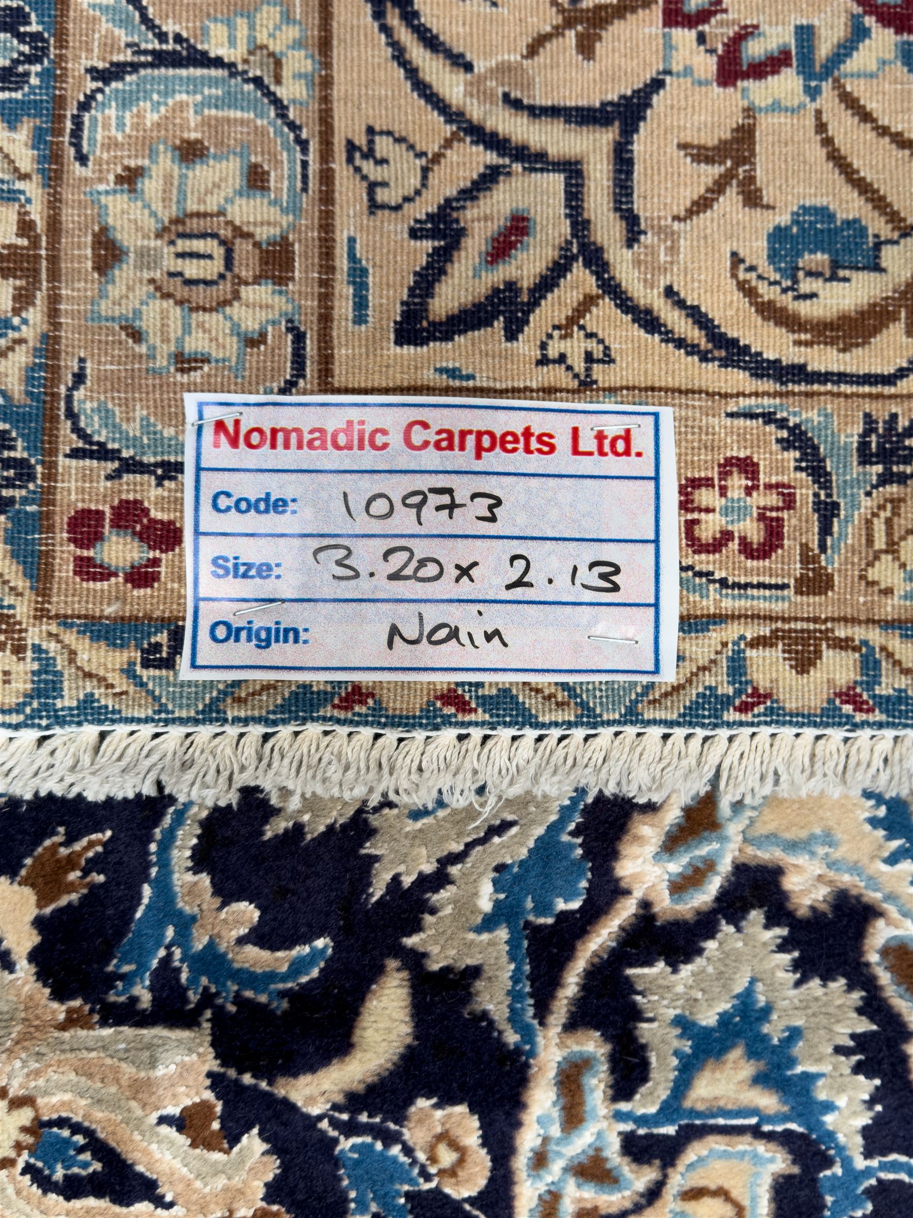 Central Persian Nain carpet, the deep blue field with finely drawn scrolling palmettes and flowering vines around a central ivory and sky blue rosette medallion, enclosed by an ivory border of interlaced floral arabesques and lotus forms between multiple guard stripes, from the region of Nain