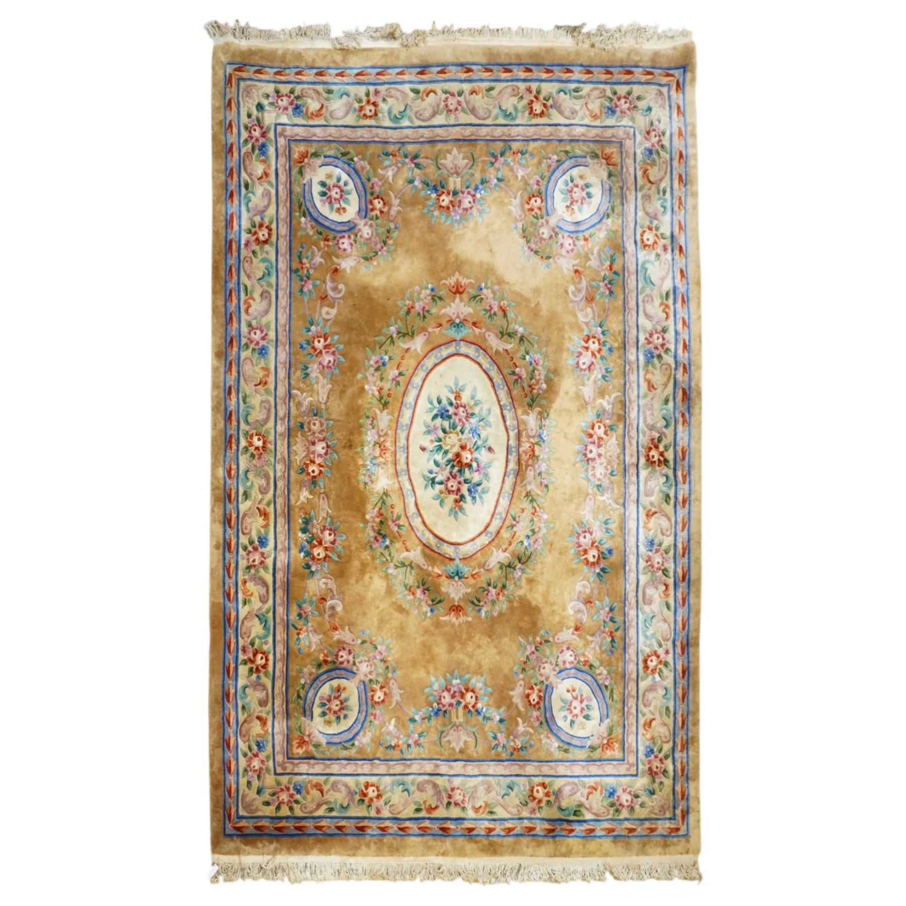 Chinese Aubusson/Savonnerie style hand-knotted carpet, ivory field with a central oval medallion issuing with stylized bouquets in shades of blush pink, pale blue, sage and green, enclosed by ribbon-tied floral garlands and conforming borders within narrow guard stripes, with cotton fringe ends 