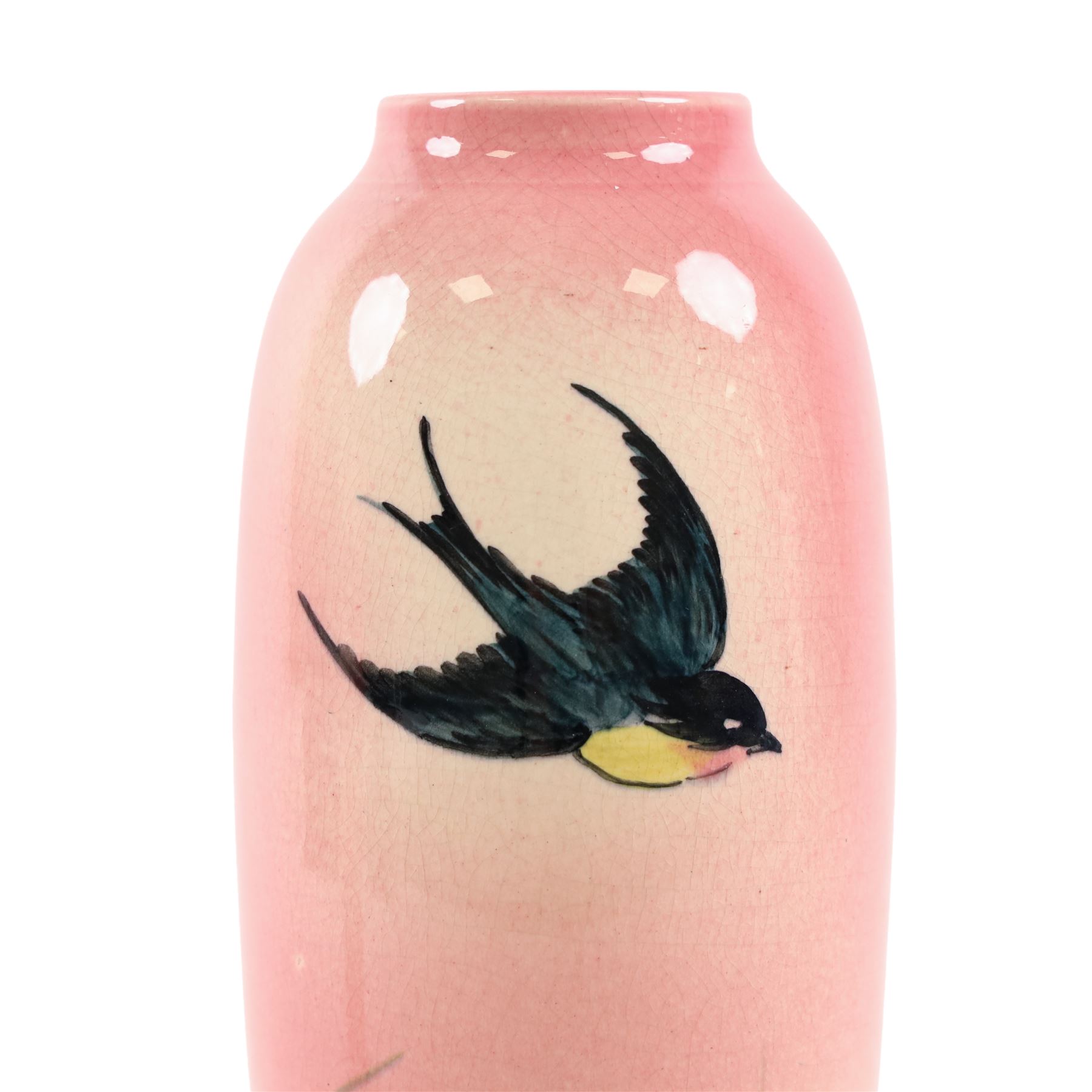 Pair Ault Pottery vases, decorated with swallows in flight upon a pink ground, H22cm