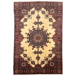 North East Persian Meshed carpet, the field with large central medallion decorated with stylised plant motifs, the field surrounded by panels, medallions and spandrels decorated with floral motifs, indigo ground border with overall floral design 
