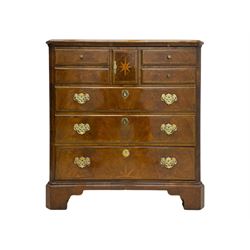 Late 20th century walnut veneered television chest in Georgian style, rectangular top over simulated drawer front with central marquetry star inlay, opening to a shelved TV compartment, lower section fitted with one long drawer, brass handles and ogee bracket feet