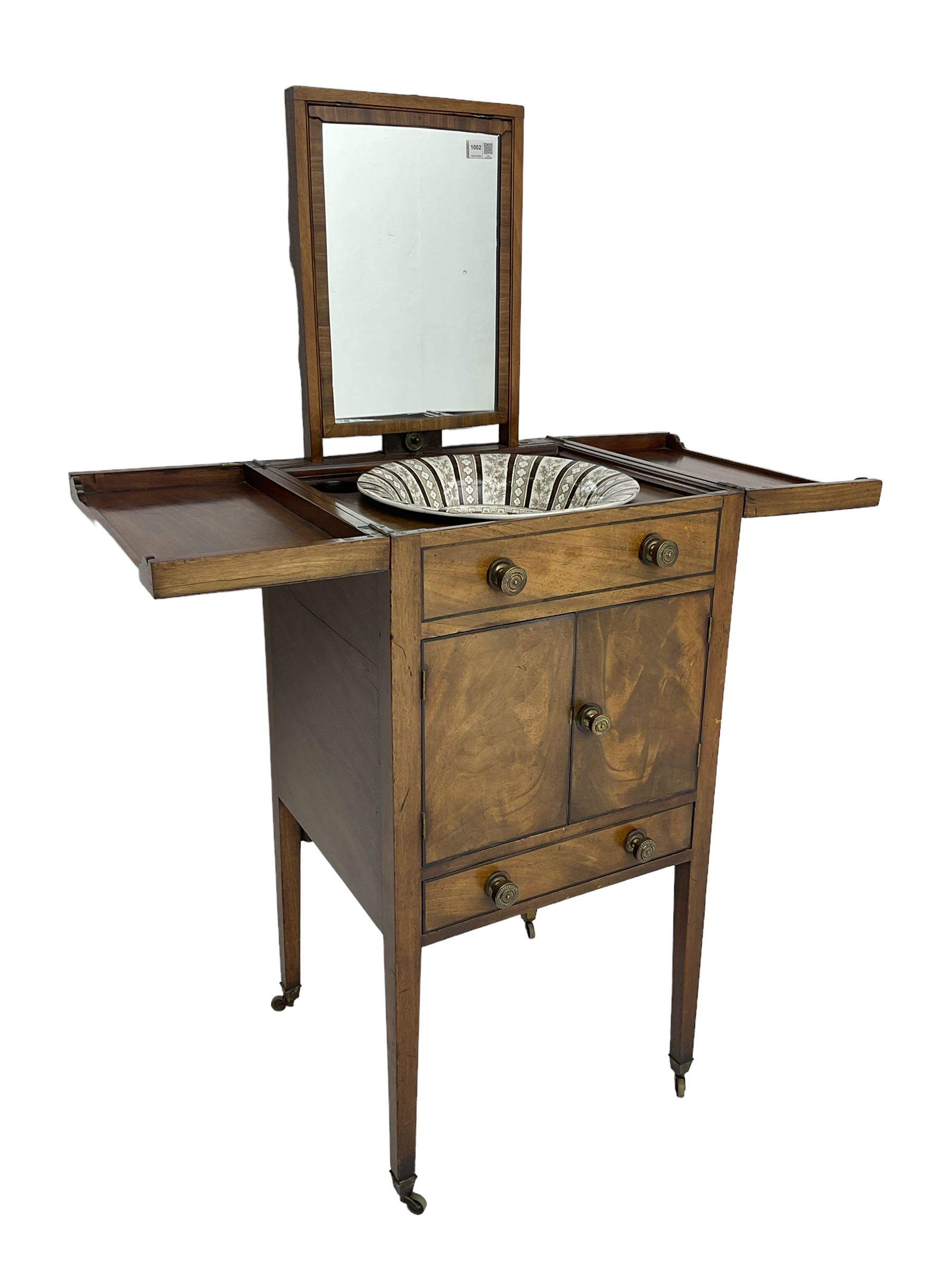Georgian mahogany washstand cabinet, the double hinged lid opens to reveal wash basin and lift up tilting mirror, false drawer over double cupboard and drawer, on square supports with brass cups and castors
