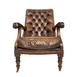 Georgian design mahogany framed library armchair, upholstered in buttoned chocolate brown leather with studwork and loose seat cushion, raised on turned supports with brass castors
