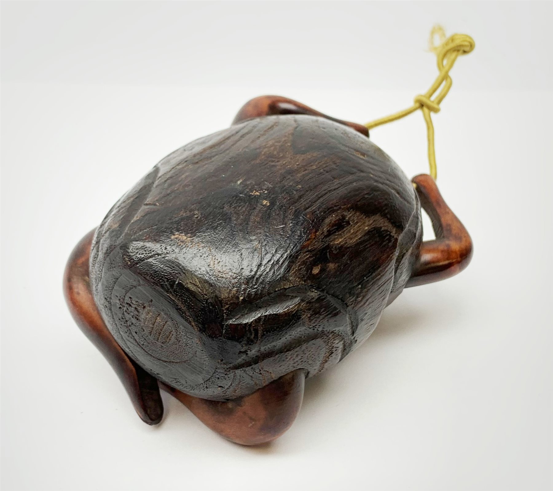 A Japanese carved soft wood inro, modelled as a streching and yawning figure, possibly Daruma, detailed with insect, inset mother of pearl butterfly, and glass eyes, H10cm. 