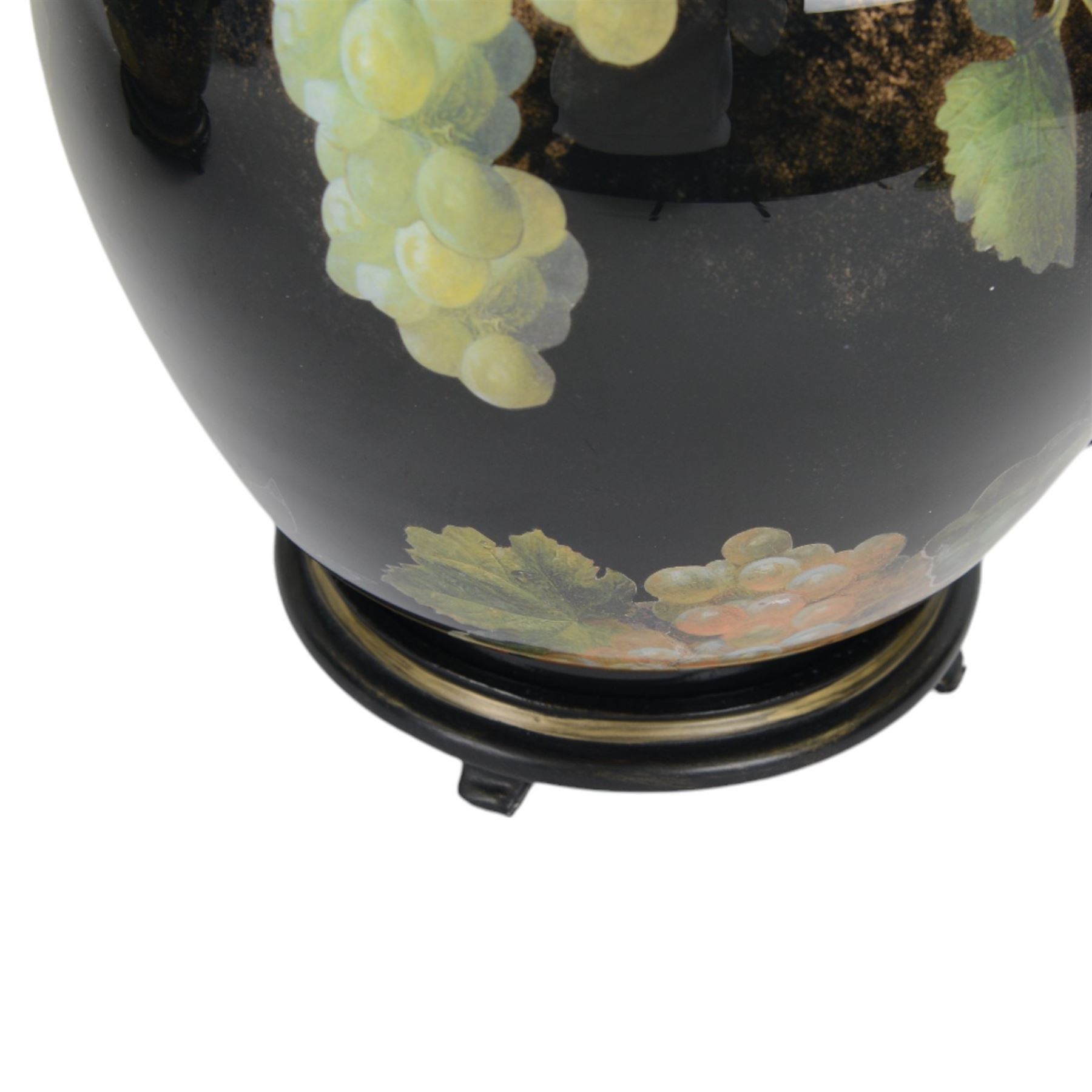 Pair of Jenny Worrall table lamps, of ovoid form, the glass body decorated with fruit and trailing flowers upon a black ground with gilt flecks, with pleated cream lampshades, including shades H65cm