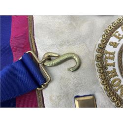 Two Masonic kid leather aprons, one with sash and cuffs, the other with sash, each marked 'Yorkshire North and East Ridings'; and three other unmarked Masonic aprons with sashes