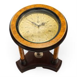 Royal Geographic Society - clock occasional table, the inset brass face with double hemisphere design and glazed top, raised on cylindrical supports united by triform platform base