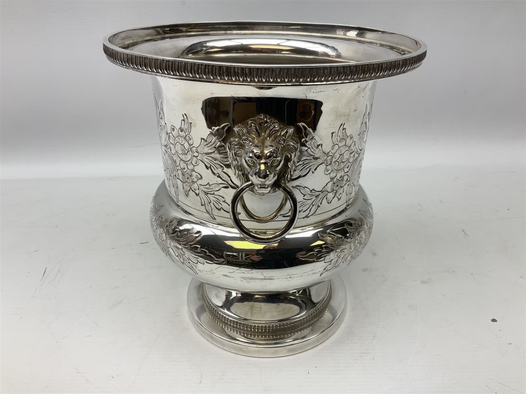Silver plated Barker Ellis wine cooler of campagna form, the body of part fluted form with twin lion mask modelled handles, upon a circular foot, impressed mark beneath, H22.5cm 