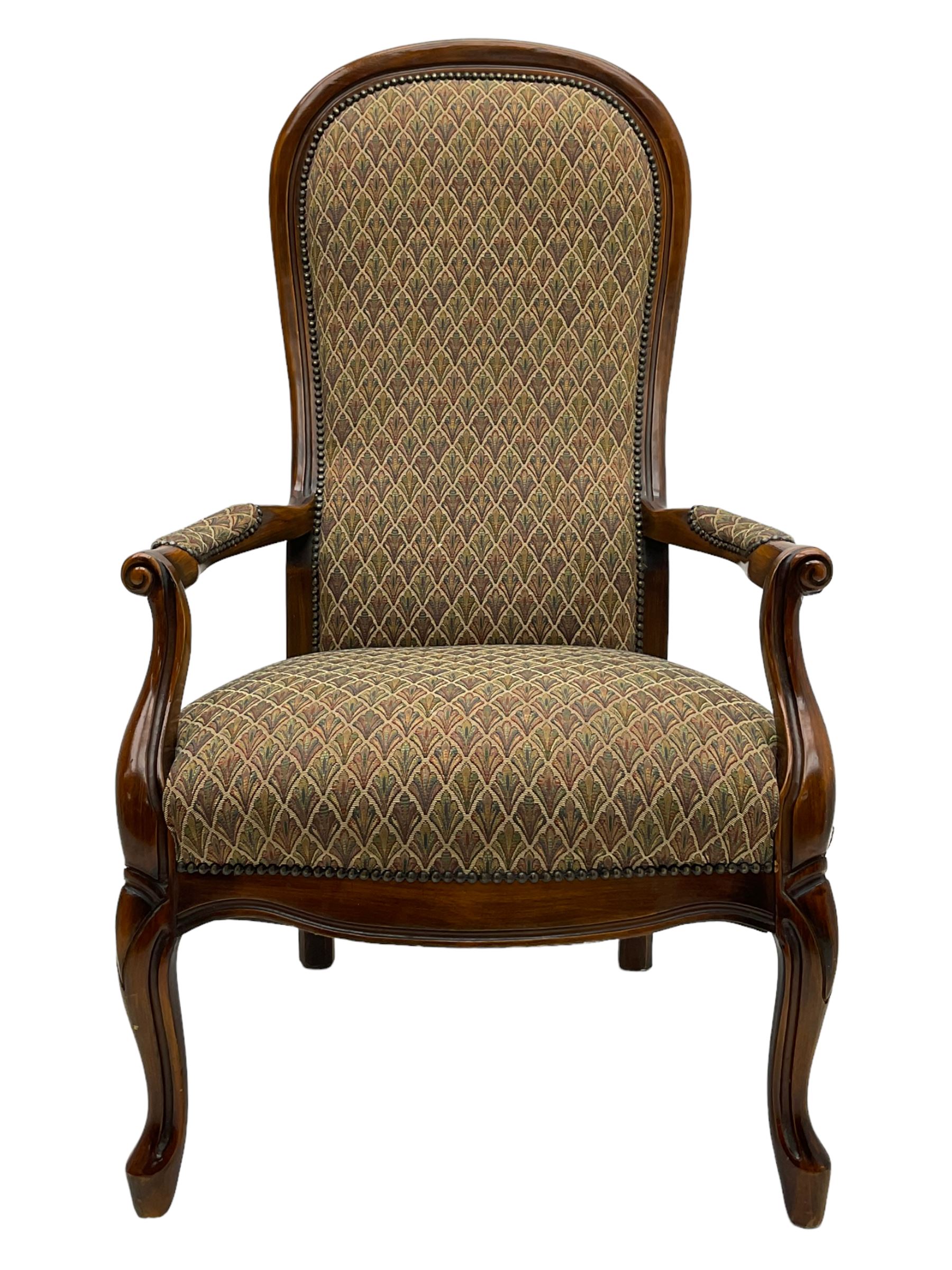 Stained beech framed open armchair, upholstered in foliate pattern fabric, on cabriole front supports