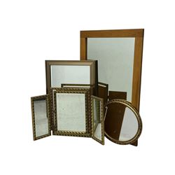 Four decorative mirrors, including gold-toned triptych dressing mirror with foliate borders, two rectangular framed mirrors and a circular gilt mirror with ornate edging