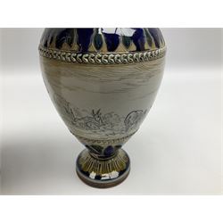 Pair of late 19th century Doulton Lambeth sgraffito vases decorated by Hannah Barlow, each of ovoid form with short neck, upon a circular spreading foot, decorated with a central sgraffito band of deer between foliate detailed borders, with impressed and incised marks beneath including monogram, H17cm