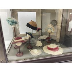 Early 20th century scratch-built wooden hat & gown shop diorama 'Joan', of double-fronted form glazed on three sides with brass and aluminium mounts, rear access apertures and storage under L63cm H45cm D31cm; with small collection of dresses and hats on display stands