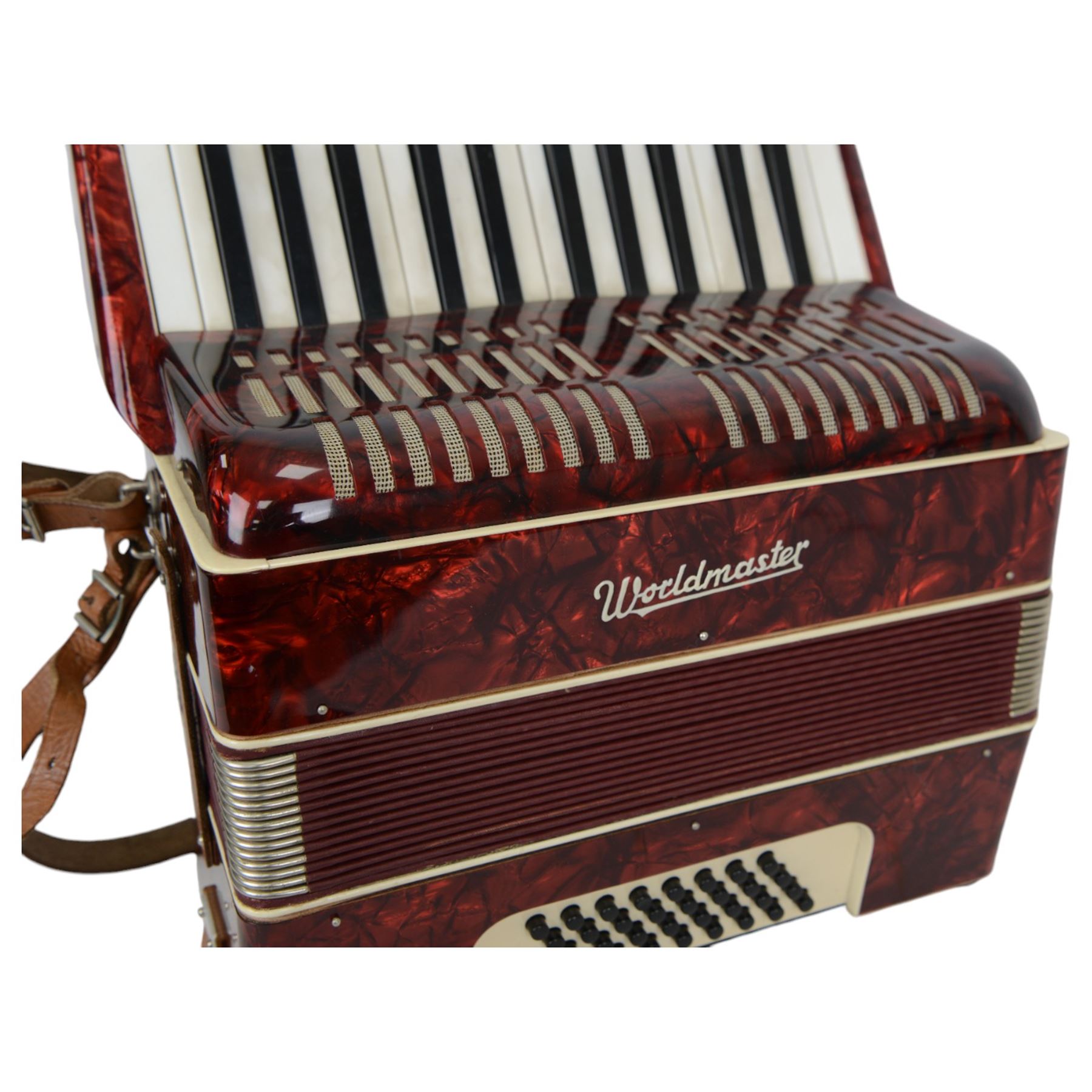 World master piano accordion with  14 fold bellows, two octave keyboard and 32 buttons. With a hard carrying case.