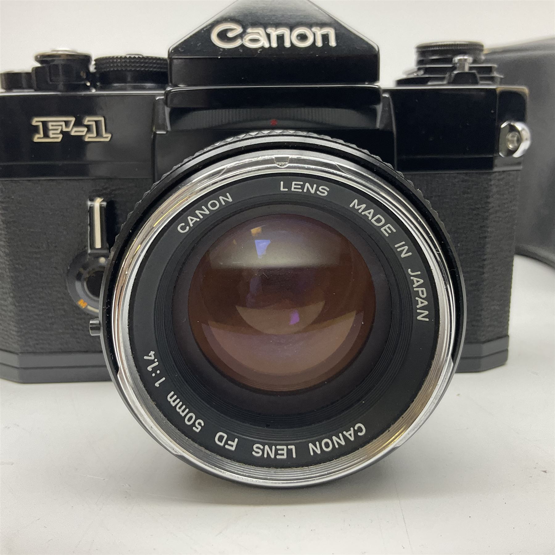 Canon F1n camera body, serial no. 572972, with 'Canon FD 50mm 1:1.4' lens, serial no. 246665, with leather case 